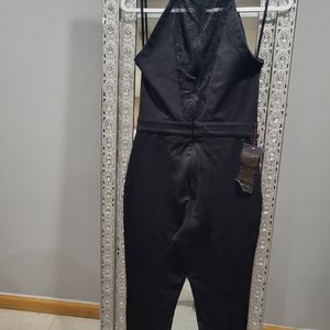 BeBe black brand new jumpsuit lace up from and back